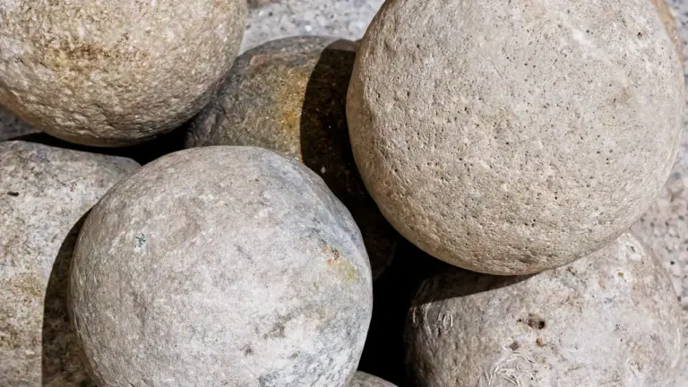 Gros plan sur des boules de pétanque en pierre naturelle bien texturées.