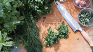 Planches en bois avec herbes aromatiques fraîches et couteau de cuisine